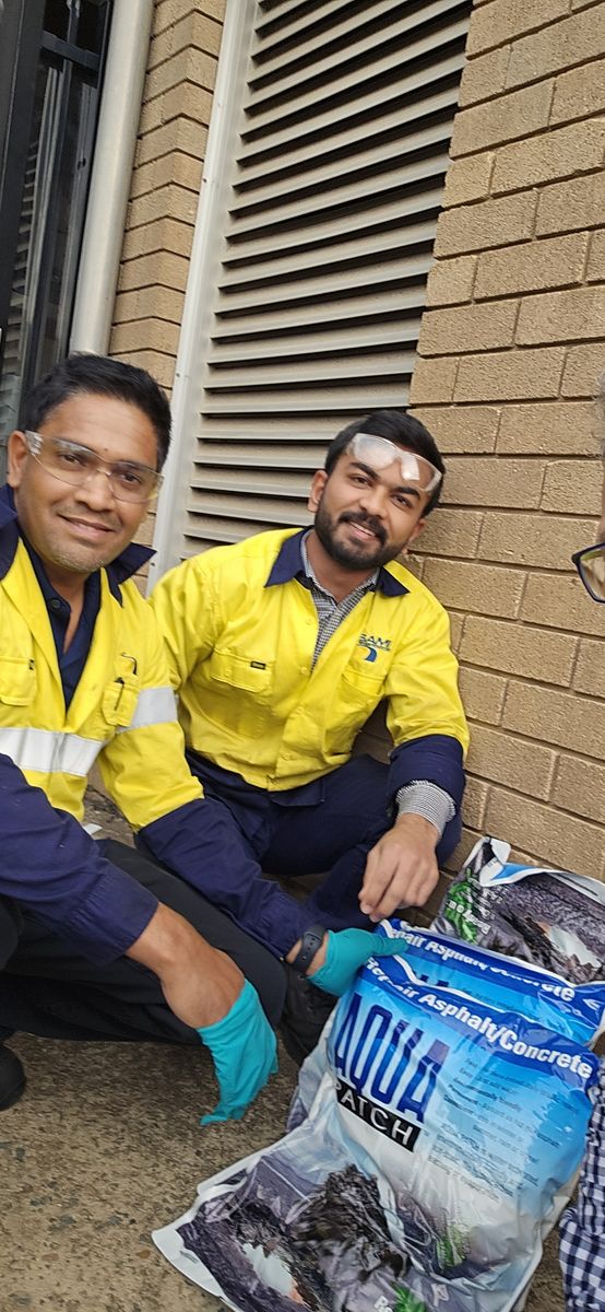 Two workers with Aqua Patch bags