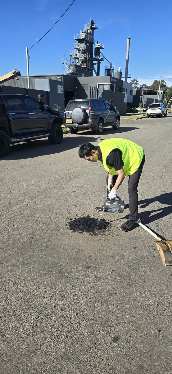 Worker applying Aqua Patch on a street