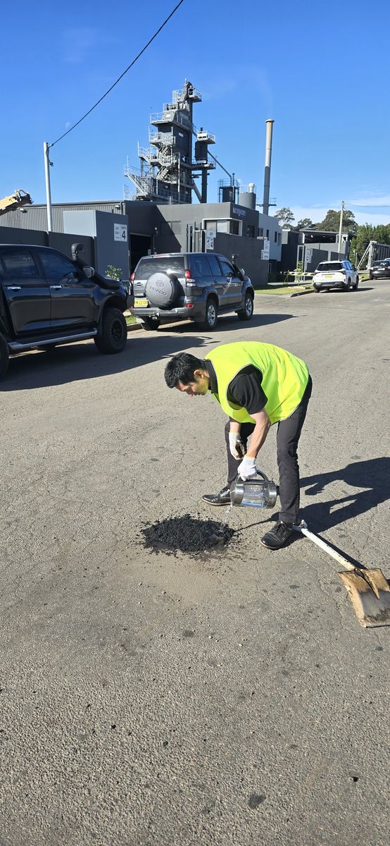 Worker pouring Aqua Patch beside a truck