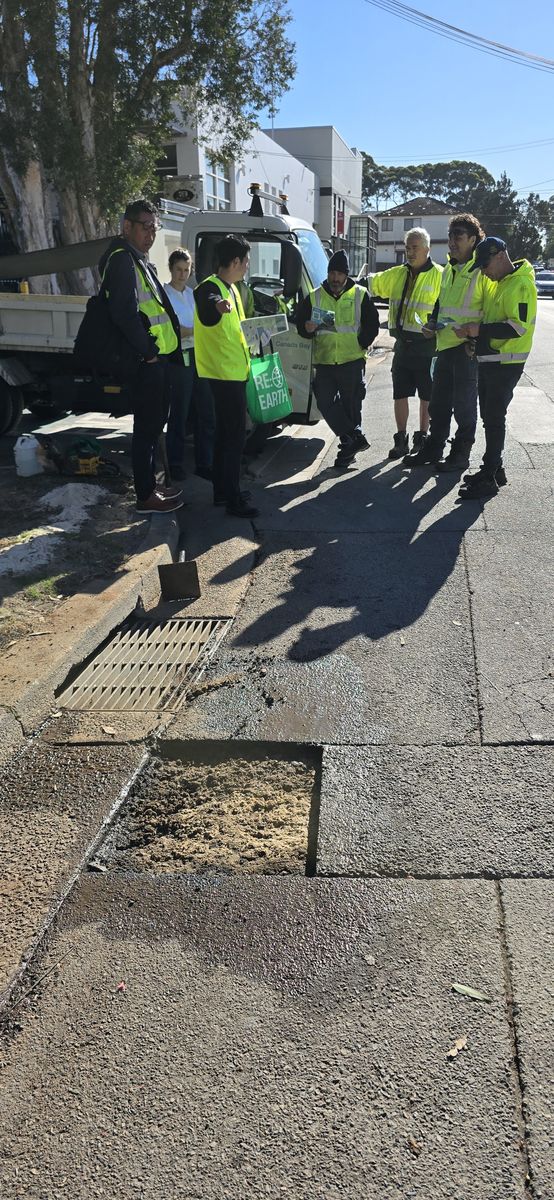 Worker inspecting a repair beside a truck