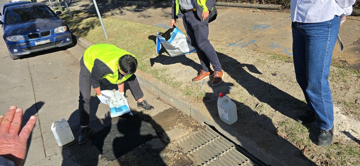 Worker pouring Aqua Patch beside a car