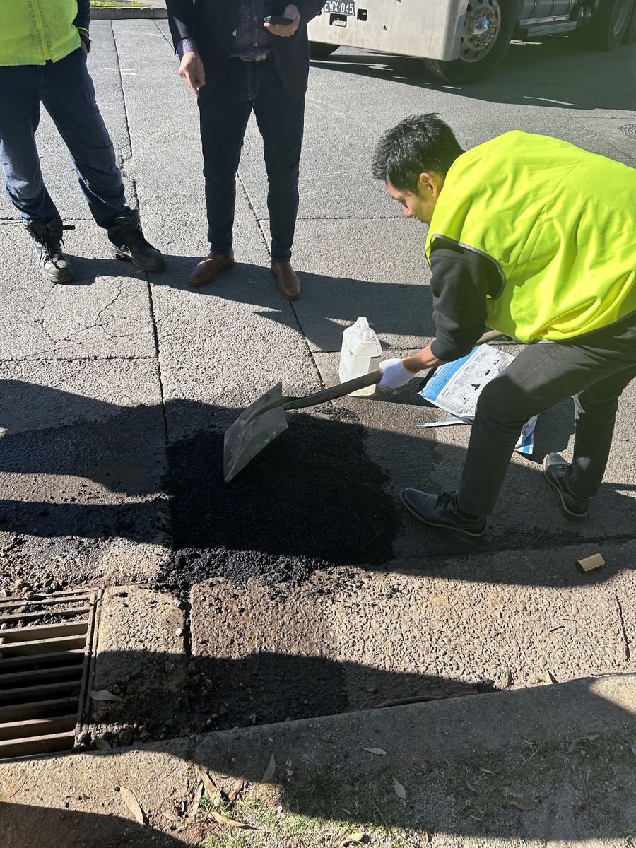 Worker applying Aqua Patch to a pothole