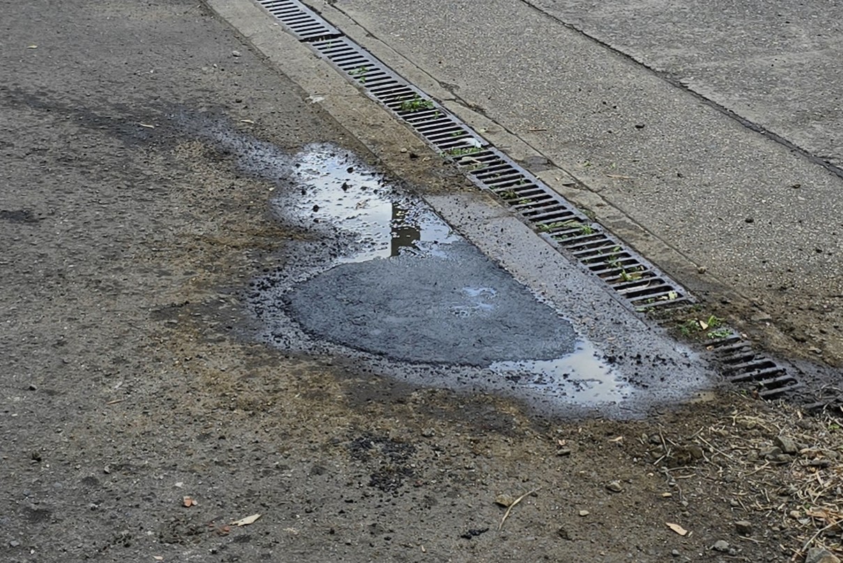 Worker pouring Aqua Patch from the bag into a pothole